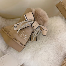 Load image into Gallery viewer, Glittery Bow Ugg Boots
